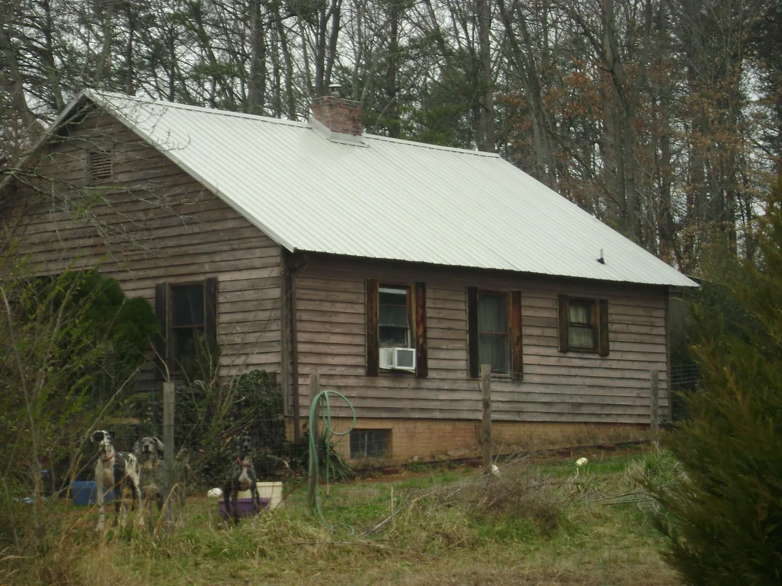 White metal roof on an old wood sided farmhouse, from a Metal Roof Installation job in Pomona